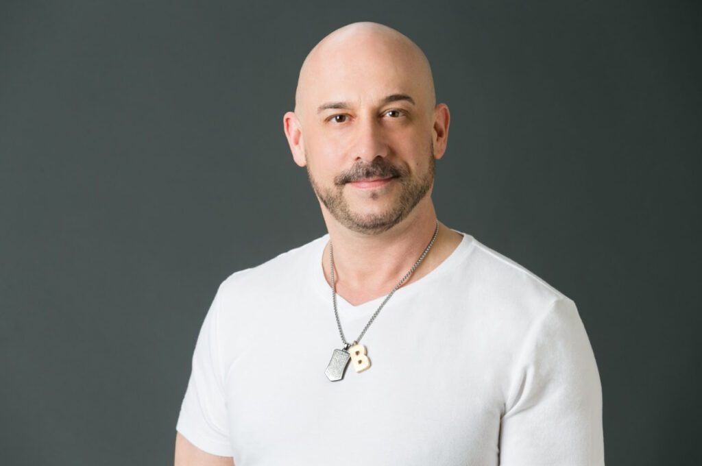 Professional headshot of DJ Howie T. Style, a premier Washington DC wedding DJ and entertainment specialist at NYX Events.