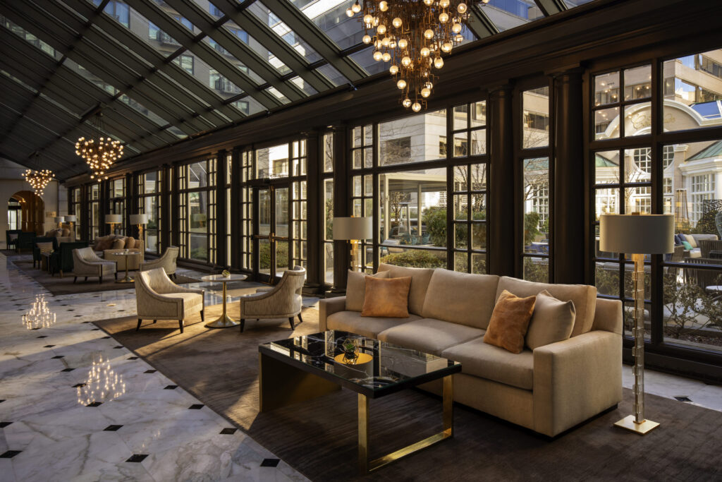 A glass-roofed hotel lounge overlooking the Courtyard.