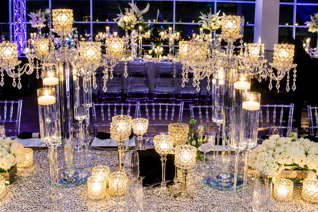 Candlelit winter wedding reception table with crystal candelabras, votive candles, and white roses in a Washington, DC ballroom